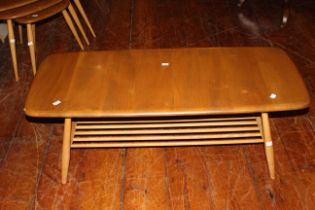 Ercol Blonde coffee table with magazine rack good used condition but small chip to one corner.