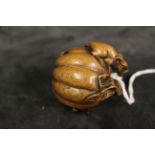 A modern Japanese netsuke carved as two mice and a pumpkin, 4.5cm high