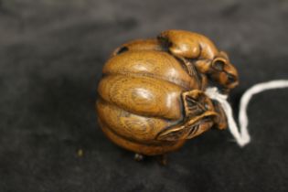 A modern Japanese netsuke carved as two mice and a pumpkin, 4.5cm high