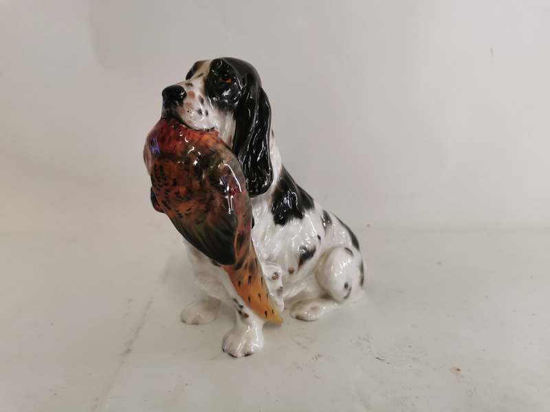 A Royal Doulton bone china figure of a spaniel holding a pheasant while sat HN 1137. 17cm high. (1)