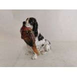 A Royal Doulton bone china figure of a spaniel holding a pheasant while sat HN 1137. 17cm high. (1)