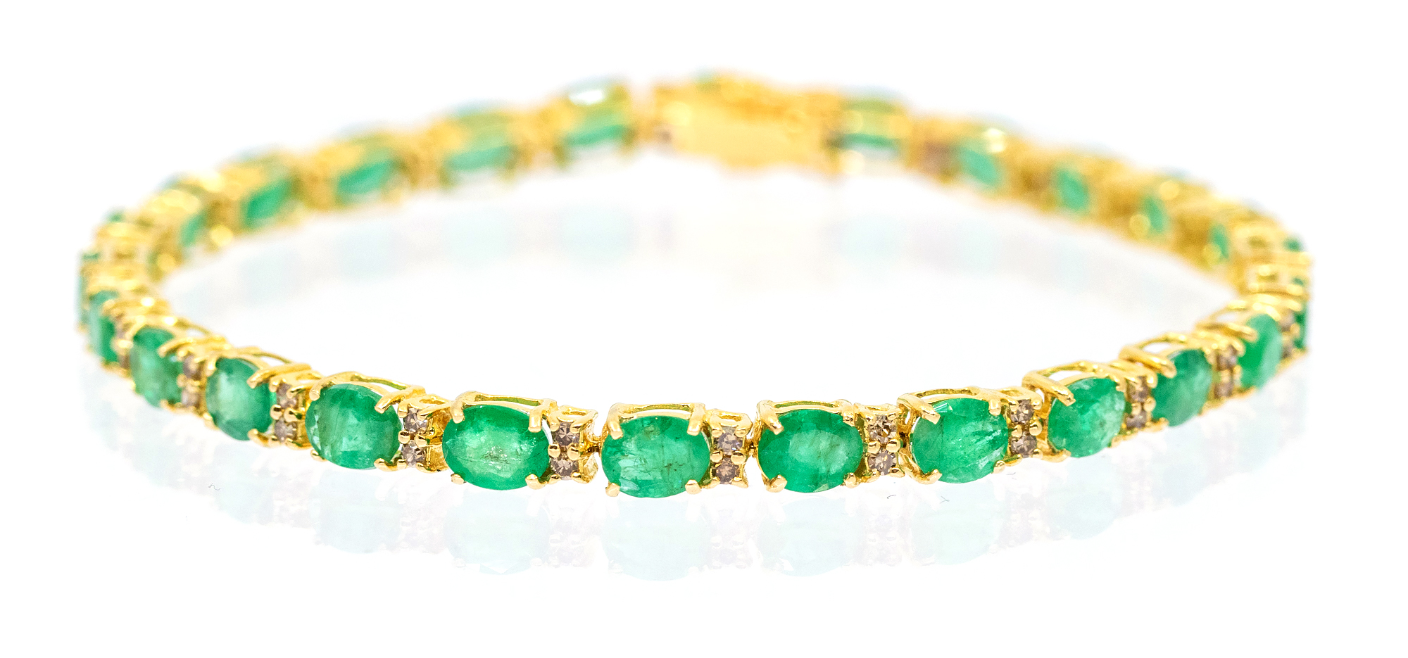 An emerald and diamond 18ct yellow gold tennis bracelet, comprising alternating oval mixed cut