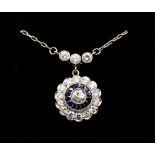 A sapphire and diamond platinum cluster pendant, comprising circular design set to the centre with a