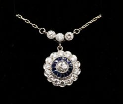 A sapphire and diamond platinum cluster pendant, comprising circular design set to the centre with a