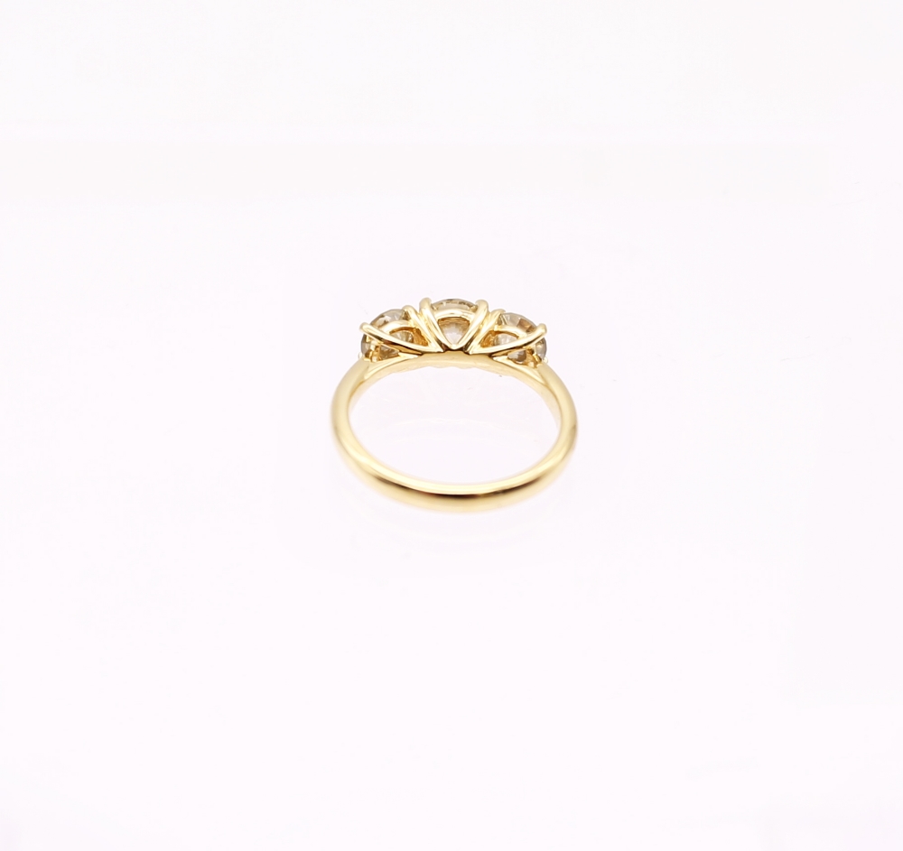 A diamond and 18ct gold trilogy ring, comprising three round brilliant cut diamonds, total diamond - Image 5 of 7