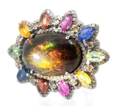 A large opal, coloured sapphire and diamond set silver dress ring, comprising a black oval galaxy
