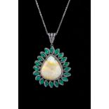 A large opal, emerald and diamond set pearl shaped silver pendant, comprising a pearl shaped opal to