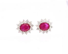 A pair of ruby and diamond set 18ct white gold oval cluster studs, rubies weighing a total of approx