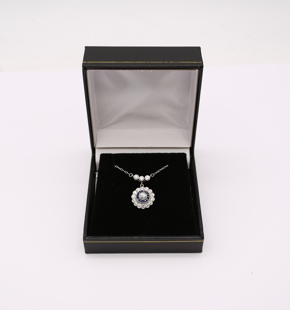 A sapphire and diamond platinum cluster pendant, comprising circular design set to the centre with a - Image 4 of 4