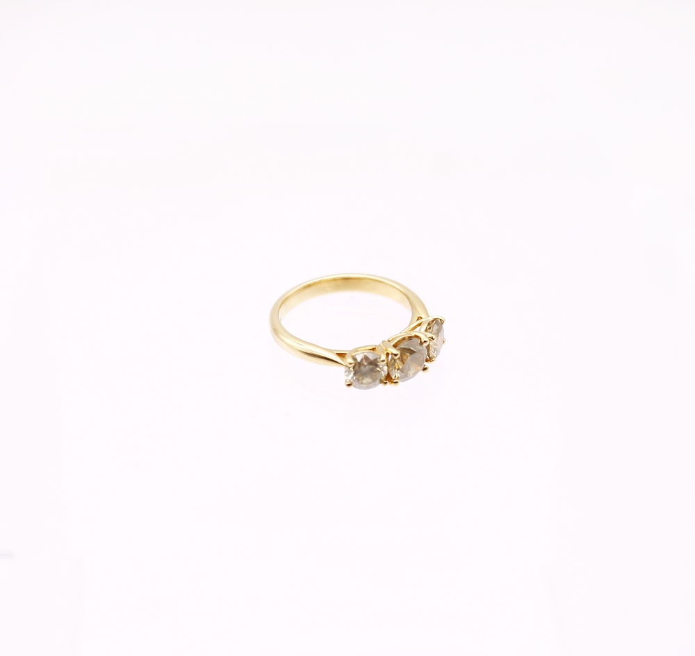 A diamond and 18ct gold trilogy ring, comprising three round brilliant cut diamonds, total diamond