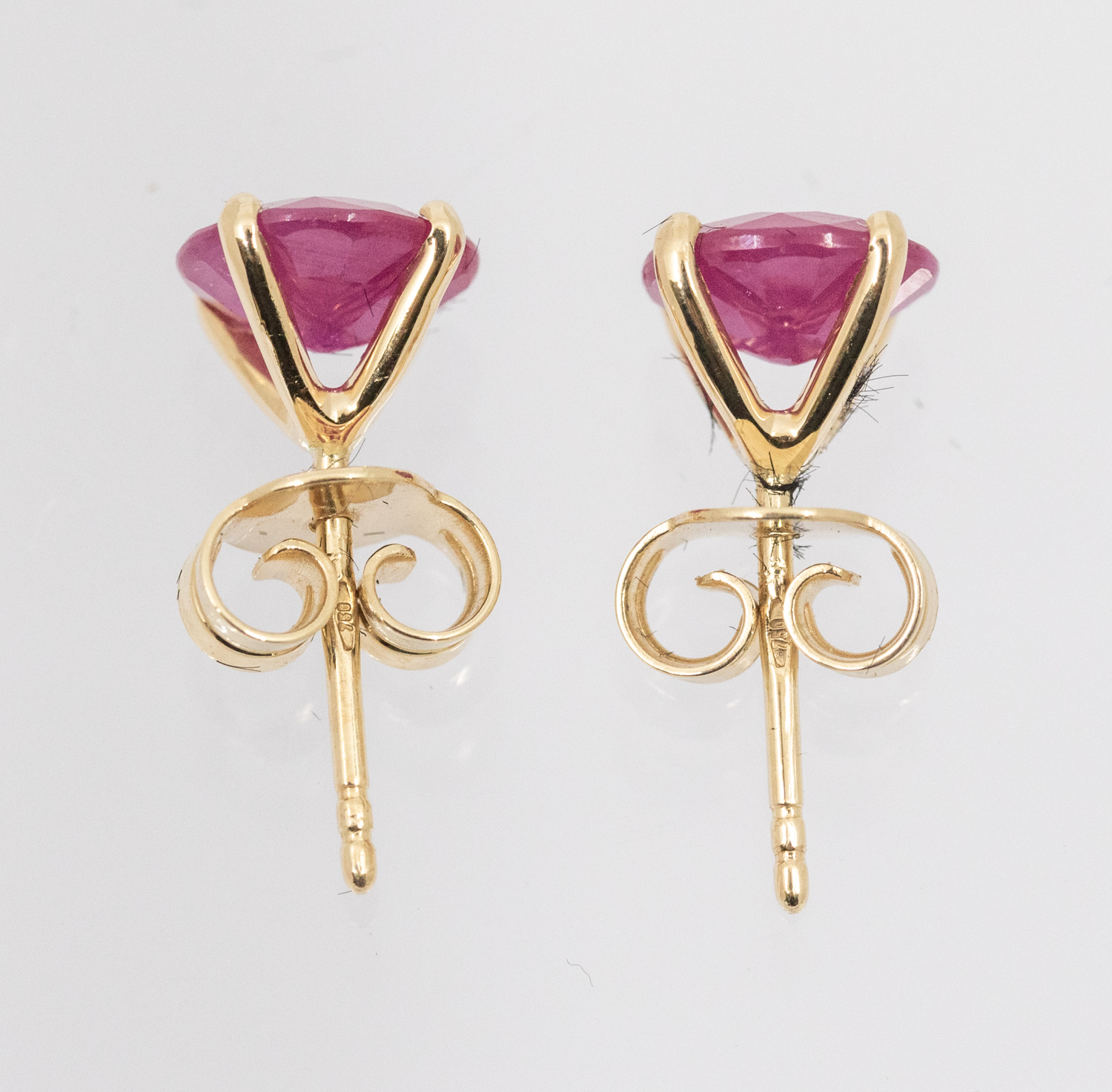 A pair of ruby and 18ct yellow gold stud earrings, claw set with with a round mixed cut rubies, - Image 3 of 3