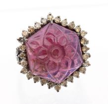 A tourmaline and diamond silver set dress ring, comprising an octagonal carved rubellite tourmaline,