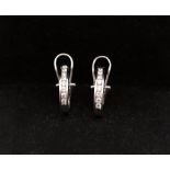 A pair of diamond and 14ct white gold diamond earrings, comprising a row of channel set round