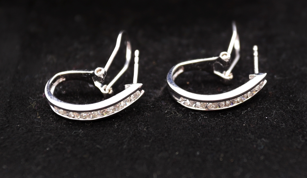 A pair of diamond and 14ct white gold diamond earrings, comprising a row of channel set round - Image 2 of 5