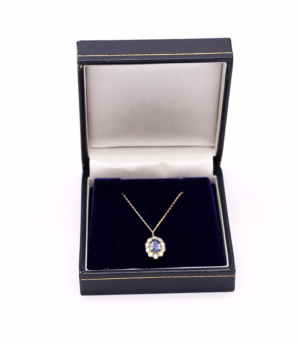 An oval sapphire and diamond 18ct gold halo pendant, the central sapphire weighing approx  0.55ct, - Image 4 of 4