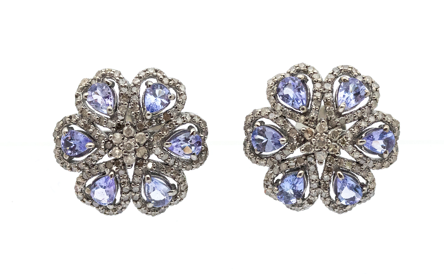 A pair of tanzanites and diamonds silver set cluster earrings, comprising pear cut tanzanites, total