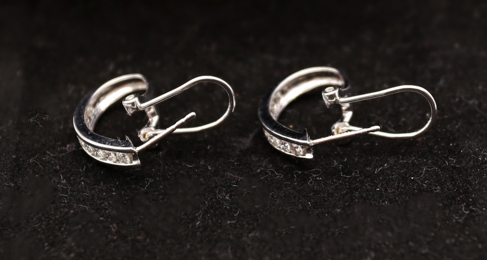 A pair of diamond and 14ct white gold diamond earrings, comprising a row of channel set round - Image 3 of 5