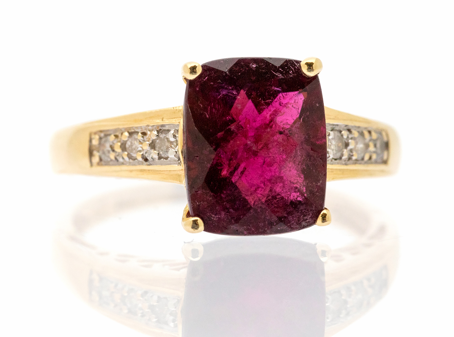 A tourmaline and diamond set 14ct yellow gold dress ring, claw set with a rectangular cushion cut