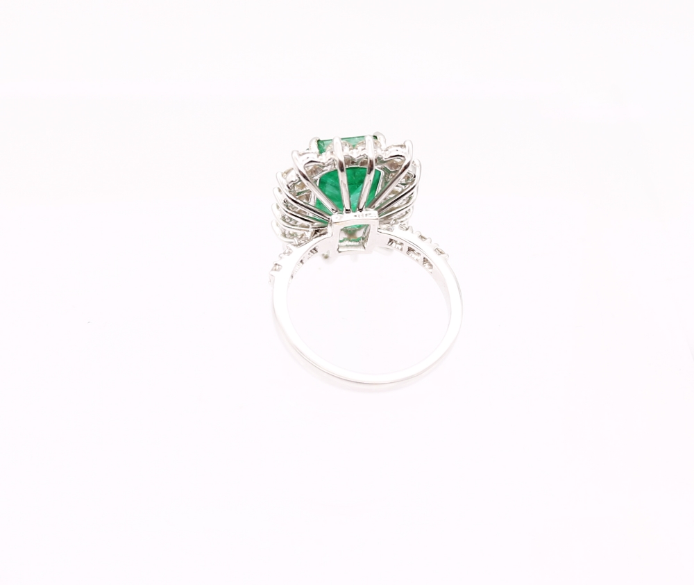 A Zambian emerald and diamond 18ct gold cluster ring, comprising a step-cut emerald (heavily - Image 4 of 7