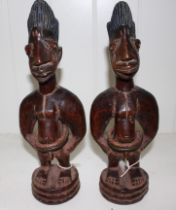 Two African carved wood Yoruba Ibeji male figures, 29cm high