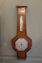 A 1930's Art Deco aneroid barometer in an inlaid walnut case 66cm high