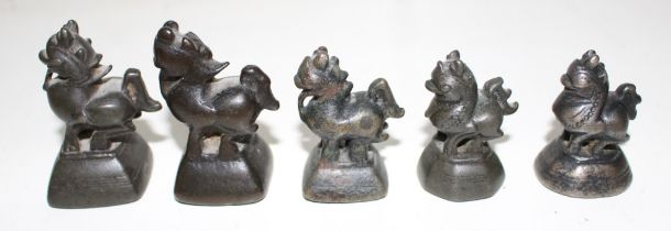 Three Burmese bronze opium weights, 4cm high and two similar bronze opium weights 5cm high