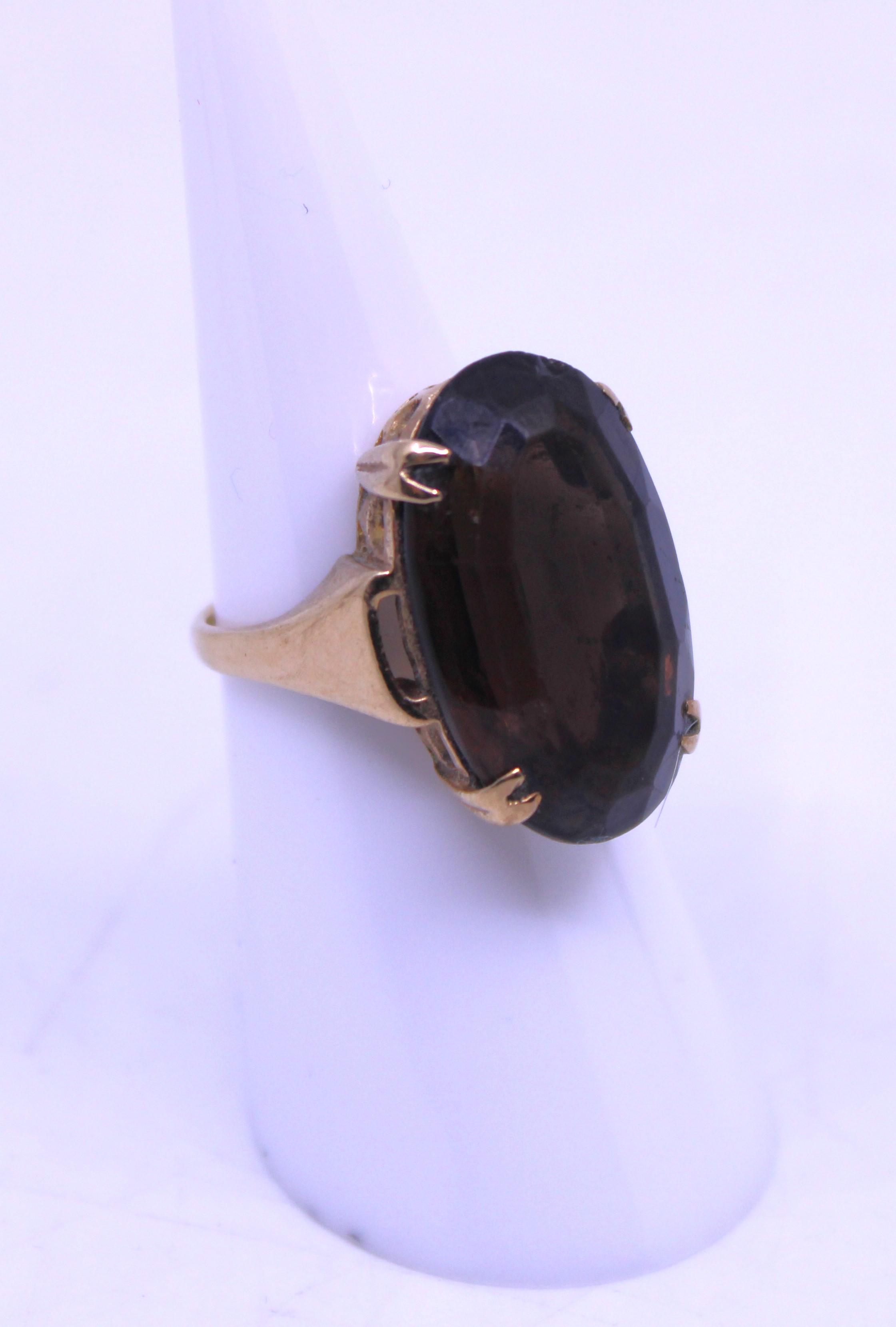 Unmarked Yellow Metal Oval Cut Brown Paste Stone Dress Ring. The Oval Cut Brown Paste Stone measures