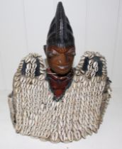 A Yoruba Ibeji figure with large cowrie shell jacket, 29cm high