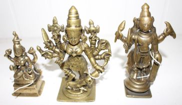 An Indian bronze figure of a deity, 11.5cm high and two others, similar 12cm and 9cm high  (3)