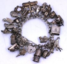 A Sterling Silver Charm Bracelet with Twenty Five Charms.  Some of the Charms are hallmarked for