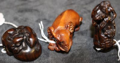 Three modern Japanese carved wood netsuke modelled as a baby elephant, signed,5.5cm long, a