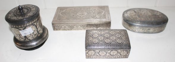 An Indian silver inlaid bidri ware cylindrical box and cover, 10cm high, an Indian white metal