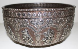 An Indian bronze bowl with applied broad band of white metal deities, 21cm diameter