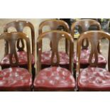A set of six Victorian mahogany and red leather button upholstered cushioned chairs with scrolling