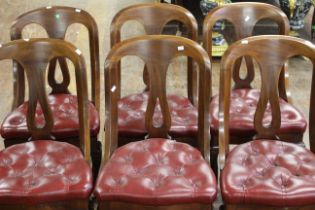 A set of six Victorian mahogany and red leather button upholstered cushioned chairs with scrolling
