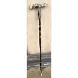 A walking cane in early 19th century style with bone handle and pierced foliate white metal