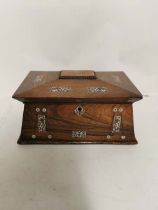A mid 19th century Rosewood and mother of pearl in laid sarcophagus shaped tea caddy with 2