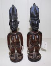 Two African carved wood Yoruba Ibeji female figures, 27cm high