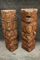 A pair of South American carved totem figures, 30cm high