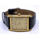 18ct Gold Gucci Tank Quartz Wristwatch with black leather strap. The rectangular shaped 18ct Gold