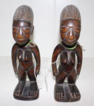 Two African carved wood Yoruba Ibeji female figures with beads, 22cm high