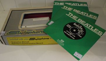 A Rolf Harris Stylophone in original box and three Beatles 45 rpm records from the singles