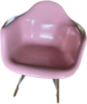 Manner of Charles & Ray Eames fibreglass, chrome and wooden feet pink tub rocking chair, by
