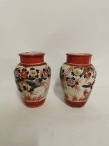 A pair of Japanese Kutani porcelain vases, hand painted with birds and flowers. Each 19cm high. Some