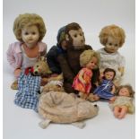 A collection of various plush toys and dolls, to include an old straw stuffed monkey, three