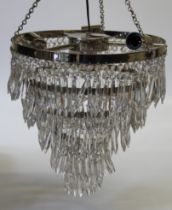 An Eichholtz five tier chrome and lustre drop chandelier