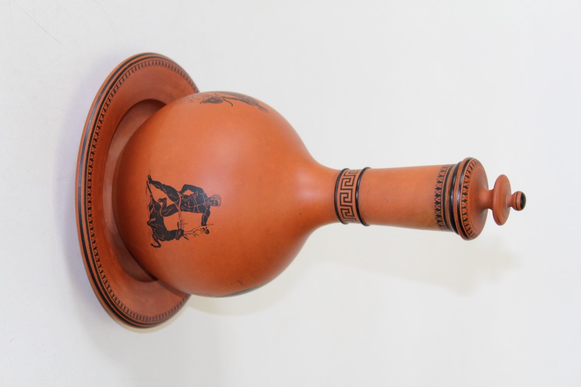 A Watcombe type Pottery terracotta onion form flask, cover and stand, transfer decorated with