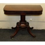 A Regency period mahogany foldover card table, the frieze centered with a rectangular panel over a