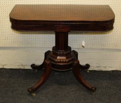 A Regency period mahogany foldover card table, the frieze centered with a rectangular panel over a