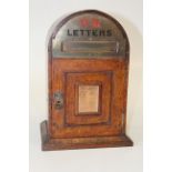 A small Victorian oak Country House letter box of domed form, with brass mount and period paper